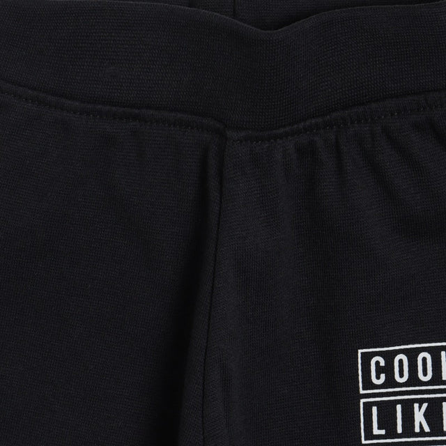 Close-up of black kids thermal wear pants with elastic waistband and white printed design