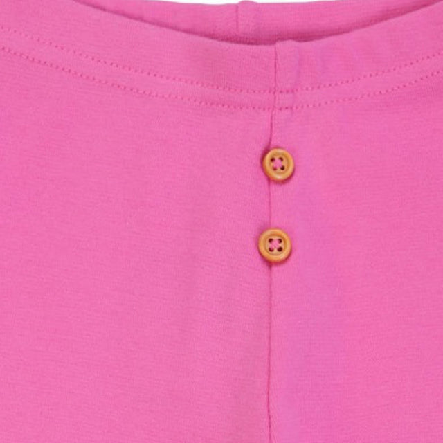 Closeup of pink kids innerwear with two yellow buttons and soft fabric