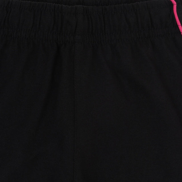 Close-up of black kids' innerwear with elastic waistband and pink piping detail