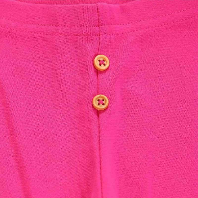 Pink kids innerwear fabric with two yellow buttons and visible stitching detail