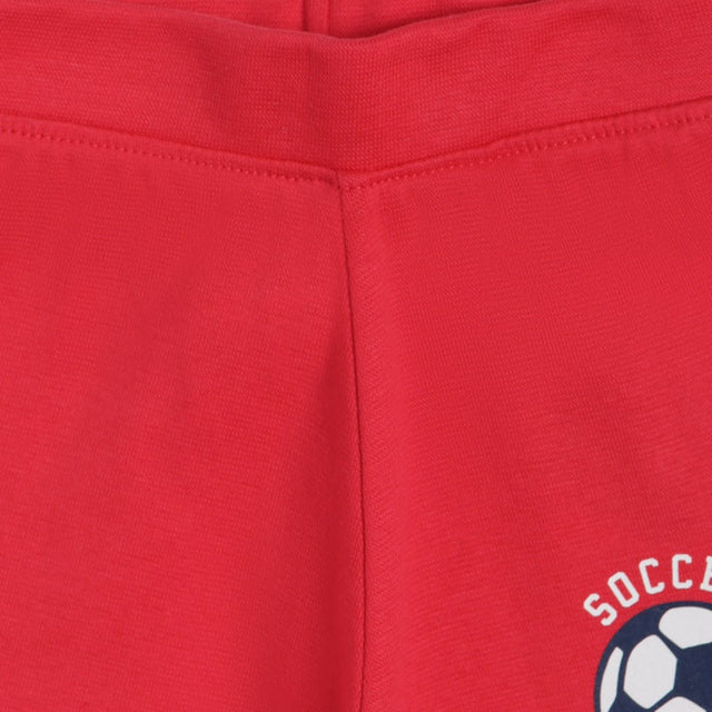 Close-up of red kids innerwear with soccer ball graphic and stitched waistband detail