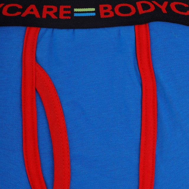 Close-up of blue kids innerwear with red trim and black elastic waistband