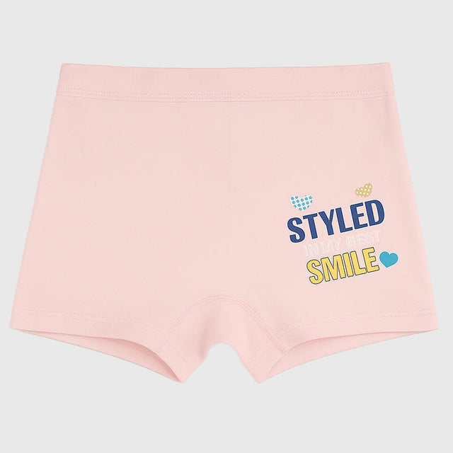 Light pink kids boyshorts with 'Styled in my best smile' slogan and small heart print