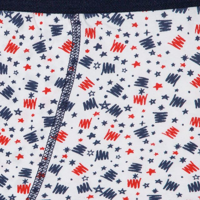 Close-up of kids innerwear fabric with red and navy star and scribble print pattern