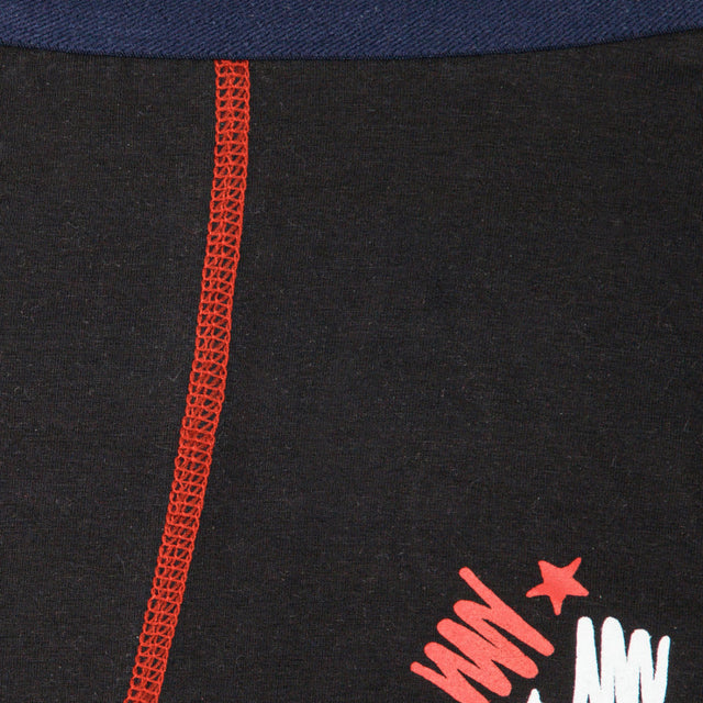 Close-up of kids black innerwear fabric with red stitching and graphic print detail