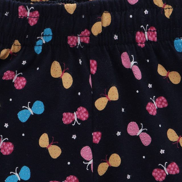 Kids innerwear close-up with colorful butterfly print on dark fabric, elastic waistband visible