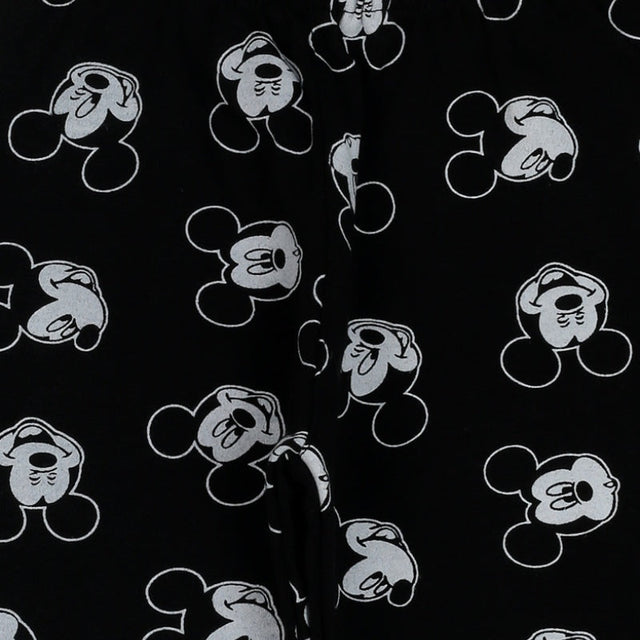 Black kids apparel fabric with white cartoon mouse face print, close-up view
