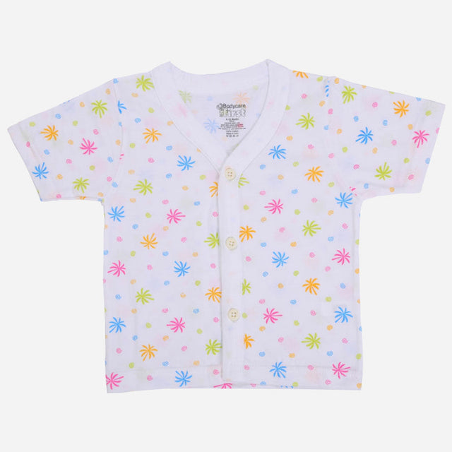 White baby shirt with colorful star and dot print, short sleeves, and front buttons