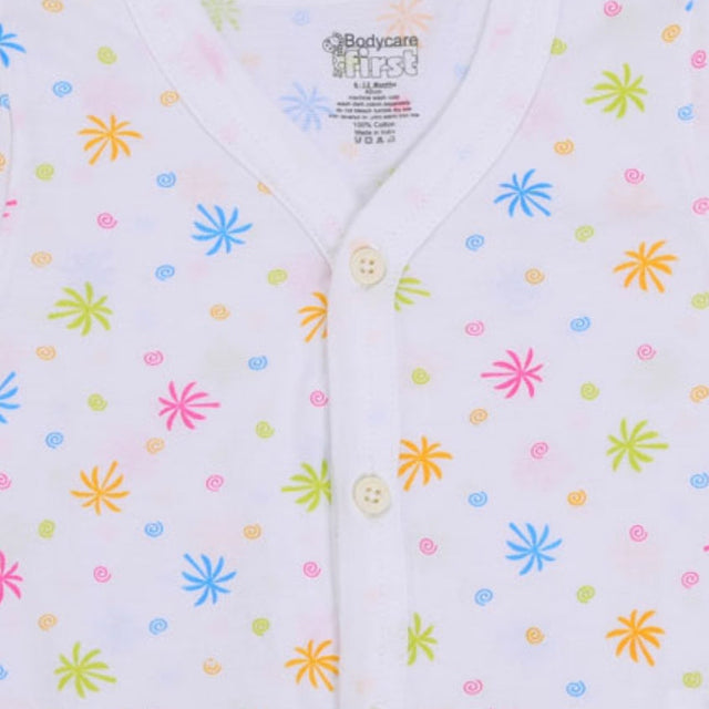 White baby vest with multicolor starburst print and front button closure