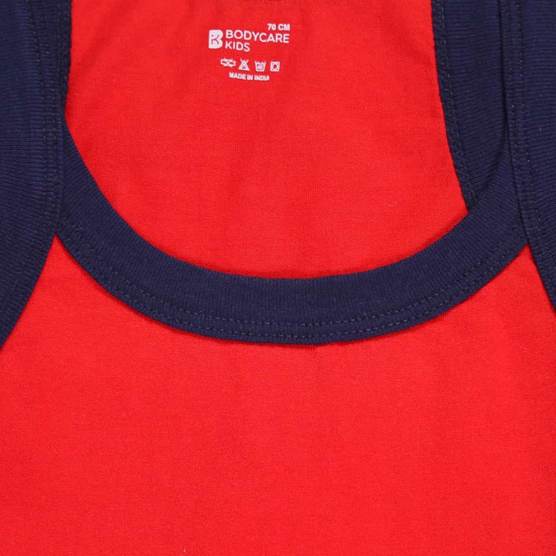 Close-up of red kids cotton innerwear vest with navy blue neckline trim