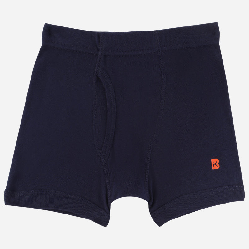 Navy blue boys boxer brief with front pouch and small orange logo on left leg