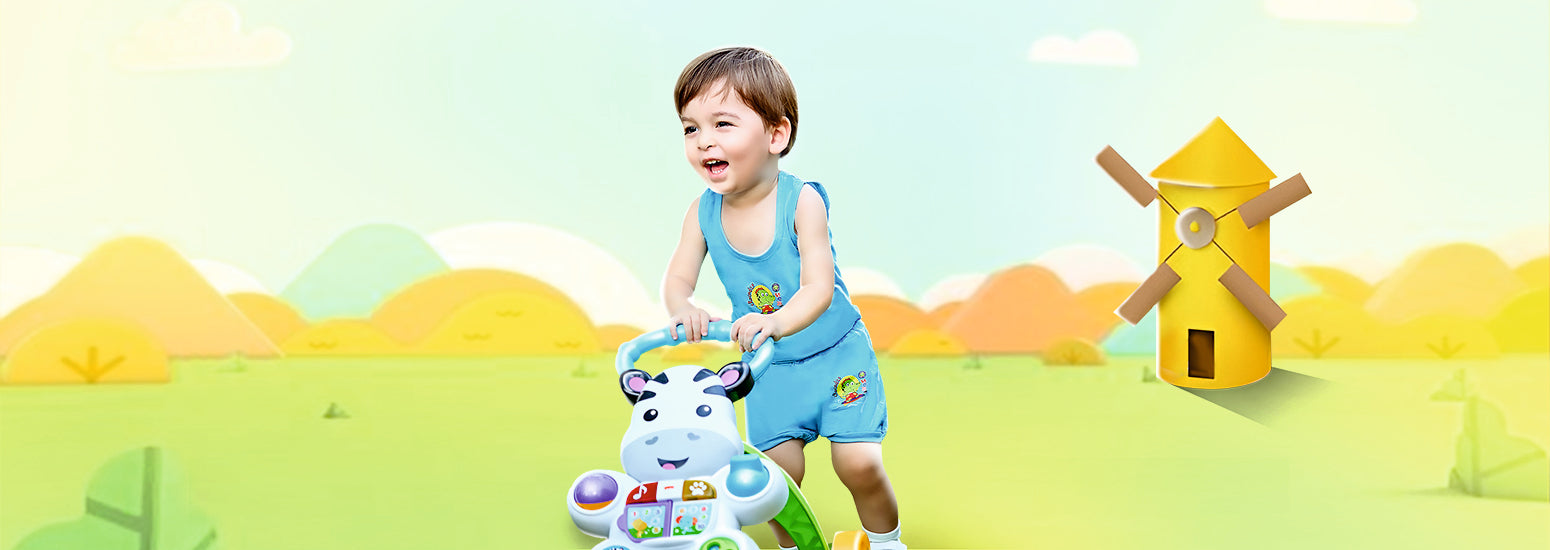 Smiling toddler in blue kids innerwear playing with push walker on a colorful outdoor background