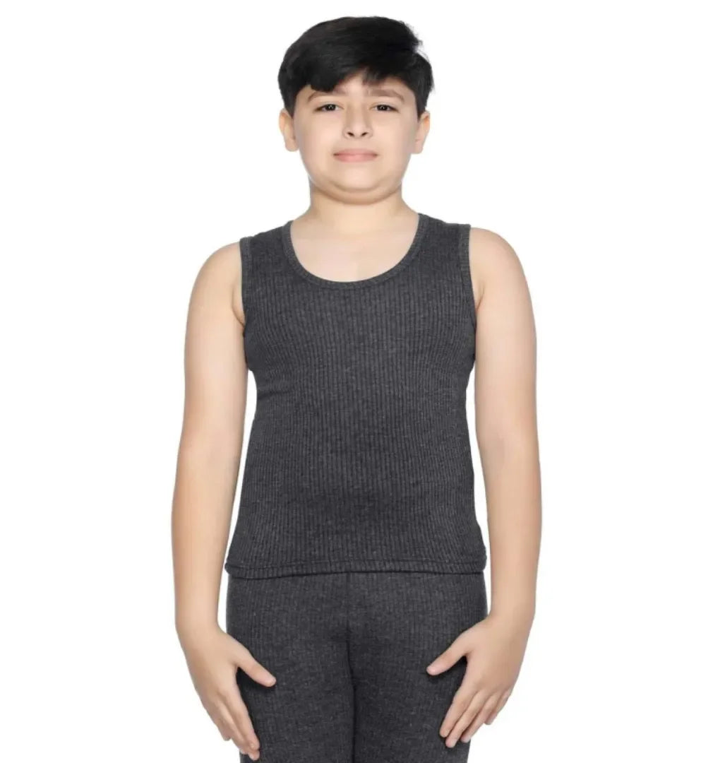 Boy wearing dark grey sleeveless thermal top and matching thermal pants, front view