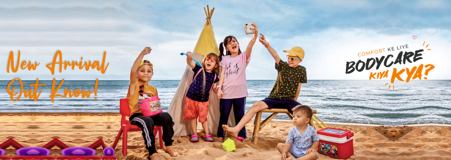 Children in comfortable summer clothing playing on a beach with a tent and toys