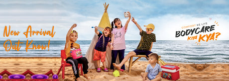 Children in comfortable summer clothing playing on a beach with a tent and toys