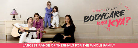 Happy family in thermal wear sitting in living room, showcasing winter thermals for all ages