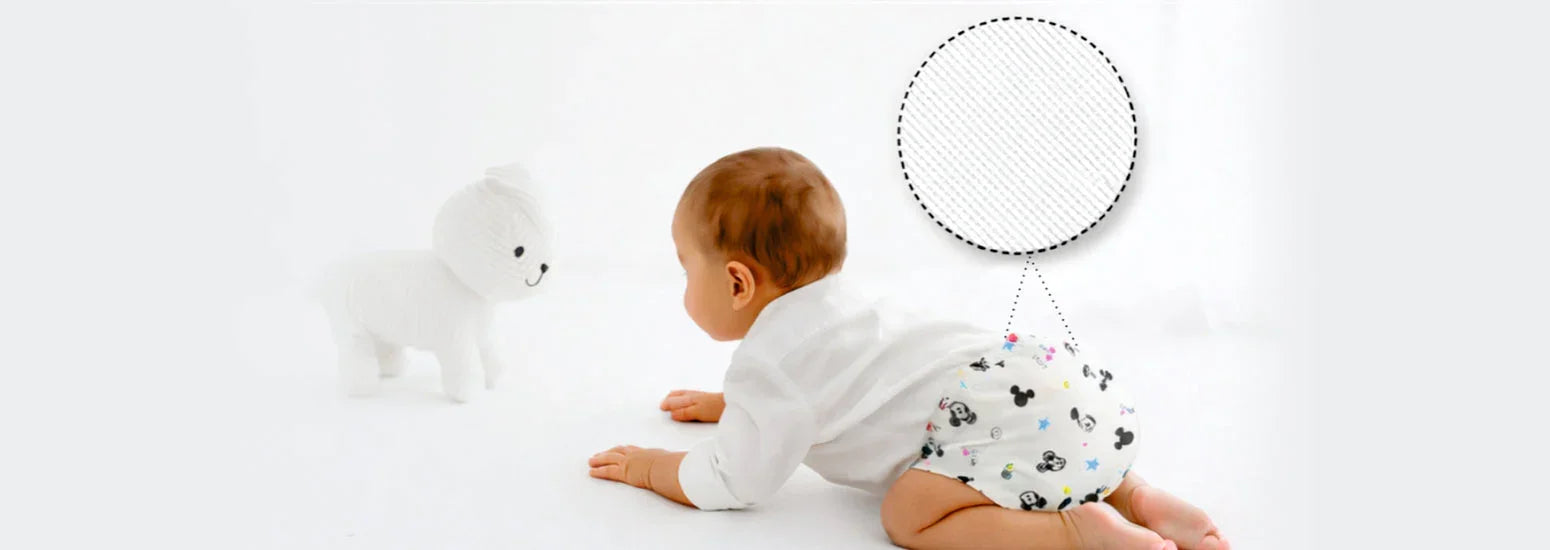 Baby crawling in soft printed diaper and innerwear, showing comfort, fit and flexible stitching
