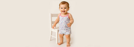 Smiling baby wearing soft cotton innerwear, highlighting gentle fabric suitable for sensitive baby skin