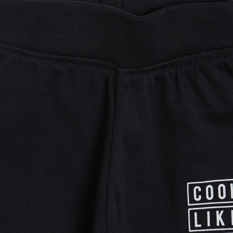 Close-up of black kids thermal wear pants with elastic waistband and white printed design