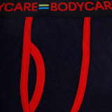 Close-up of navy blue kids underwear with red trim and elastic waistband details