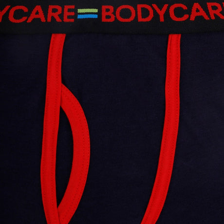 Close-up of navy blue kids underwear with red trim and elastic waistband details