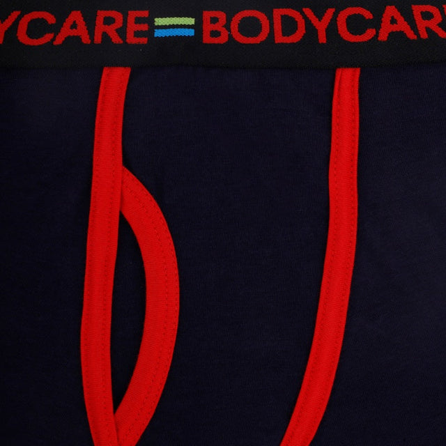 Close-up of navy blue kids underwear with red trim and elastic waistband details