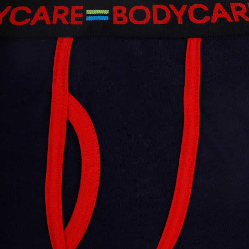 Close-up of navy blue kids underwear with red trim and elastic waistband details