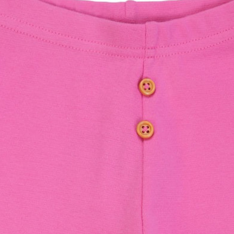 Closeup of pink kids innerwear with two yellow buttons and soft fabric