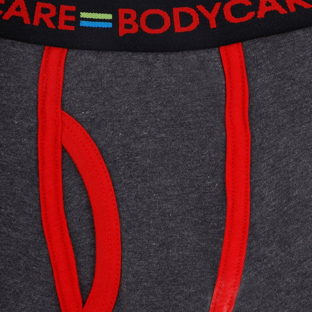 Close-up of kids' grey innerwear with red seams and elastic waistband detail