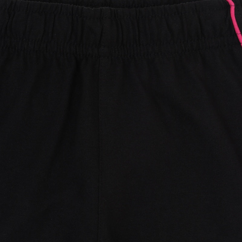 Close-up of black kids' innerwear with elastic waistband and pink piping detail