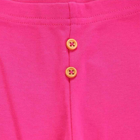 Pink kids innerwear fabric with two yellow buttons and visible stitching detail