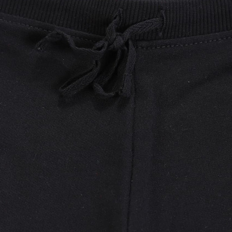 Close-up of black kids joggers with ribbed waistband and drawstring tie