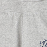 Close-up of light grey kids' cotton apparel with soft fabric texture and visible stitching