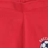 Close-up of red kids innerwear with soccer ball graphic and stitched waistband detail