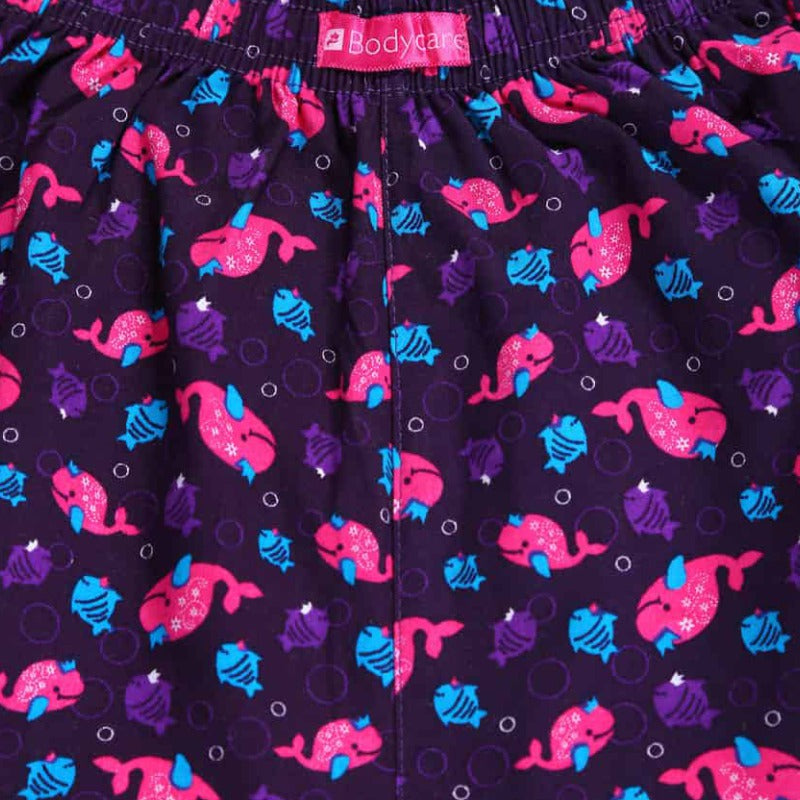 Close-up of kids' innerwear with purple fabric, pink and blue cartoon fish, elastic waistband