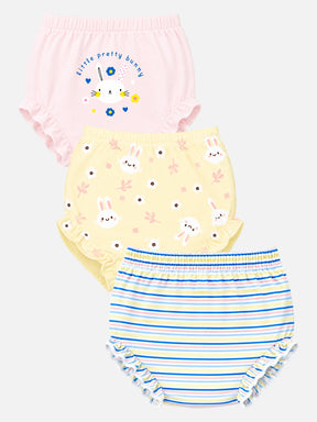 Three pairs of baby bloomers in a three-pack, featuring a pink pair with bunny graphics and text, a pale yellow pair with bunny faces and flowers, and a blue and white striped pair with ruffled edges.