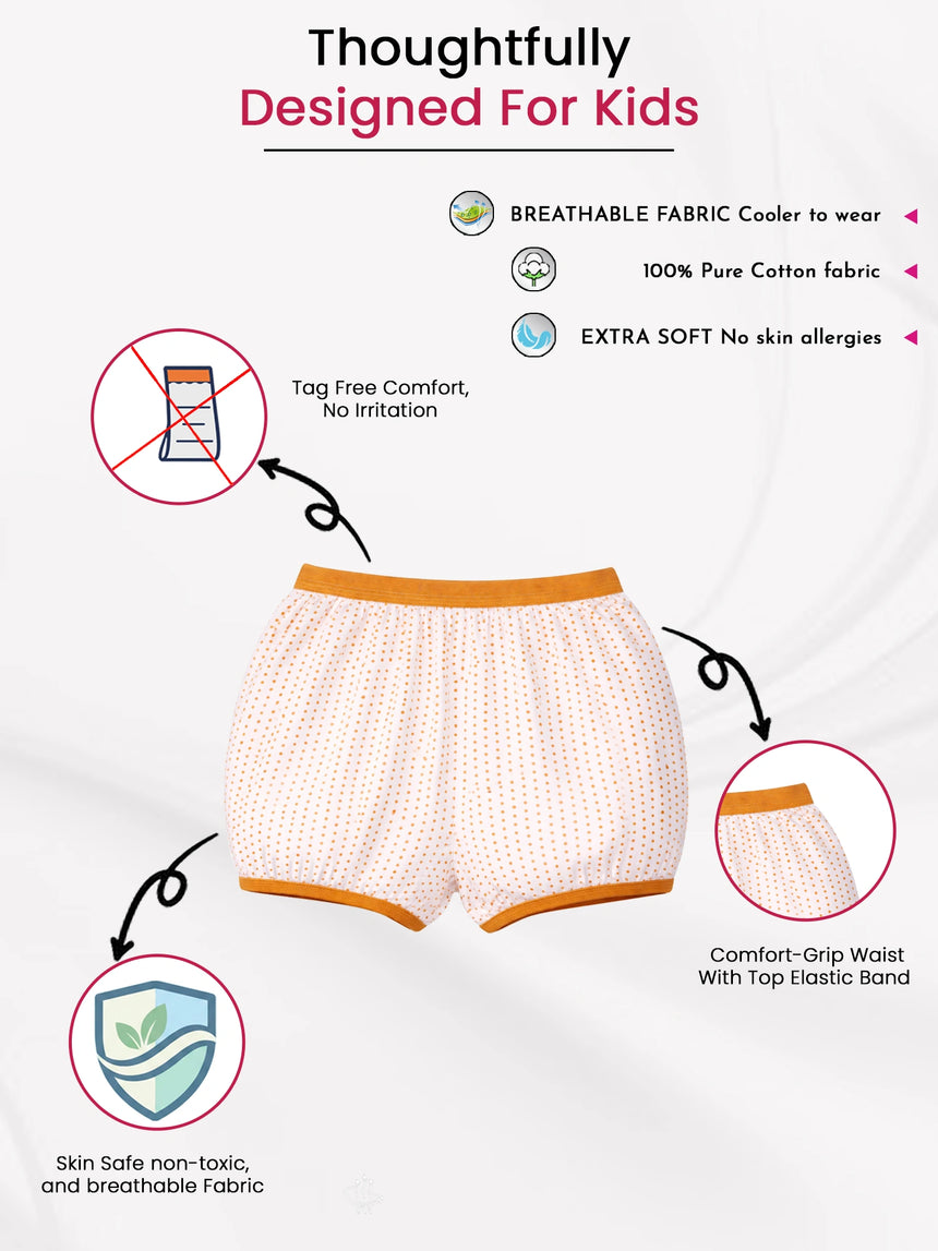 Kids' innerwear shorts with orange polka dots, breathable cotton, tag-free, soft elastic waist.