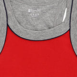 Red kids thermal innerwear with grey ribbed neckline, close-up fabric texture