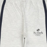 Light grey kids joggers with navy side stripes and 'Chic & trendy' palm tree print