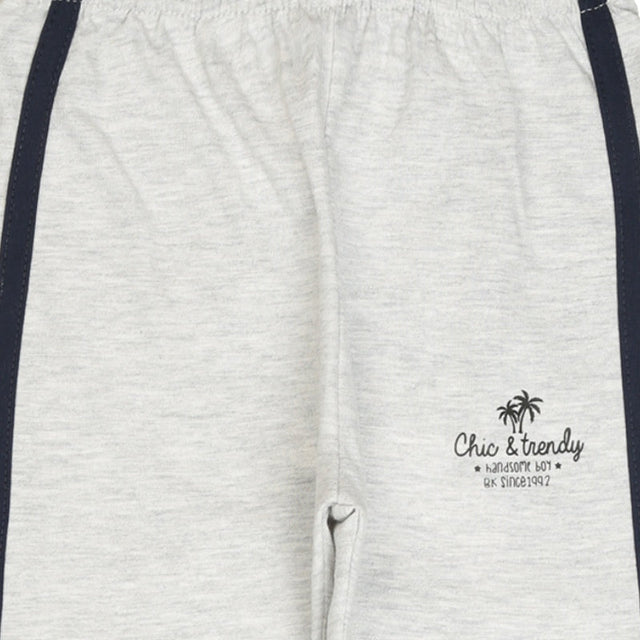Light grey kids joggers with navy side stripes and 'Chic & trendy' palm tree print