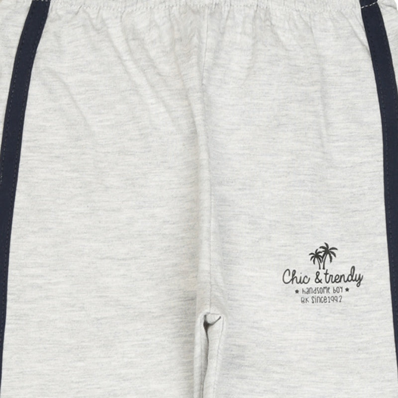 Light grey kids joggers with navy side stripes and 'Chic & trendy' palm tree print
