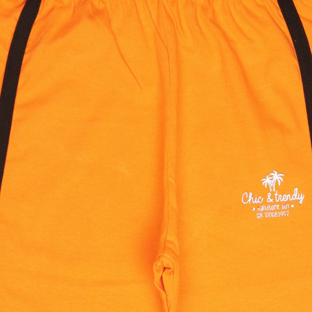 Orange kids shorts with elastic waistband, black side stripes, and 'Chic & trendy' print