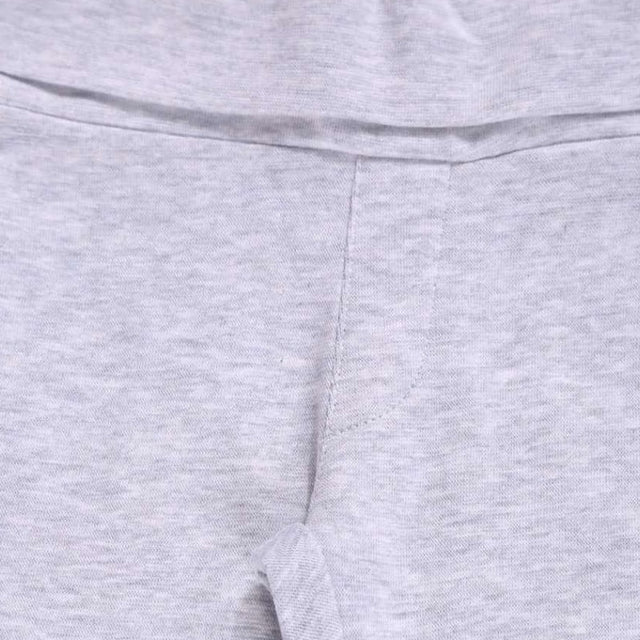 Close-up of light grey kids innerwear fabric with soft stitching and elastic waistband.