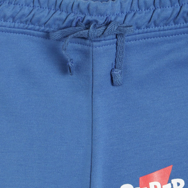 Close-up of blue kids' elastic waist shorts with drawstring and partial printed graphic
