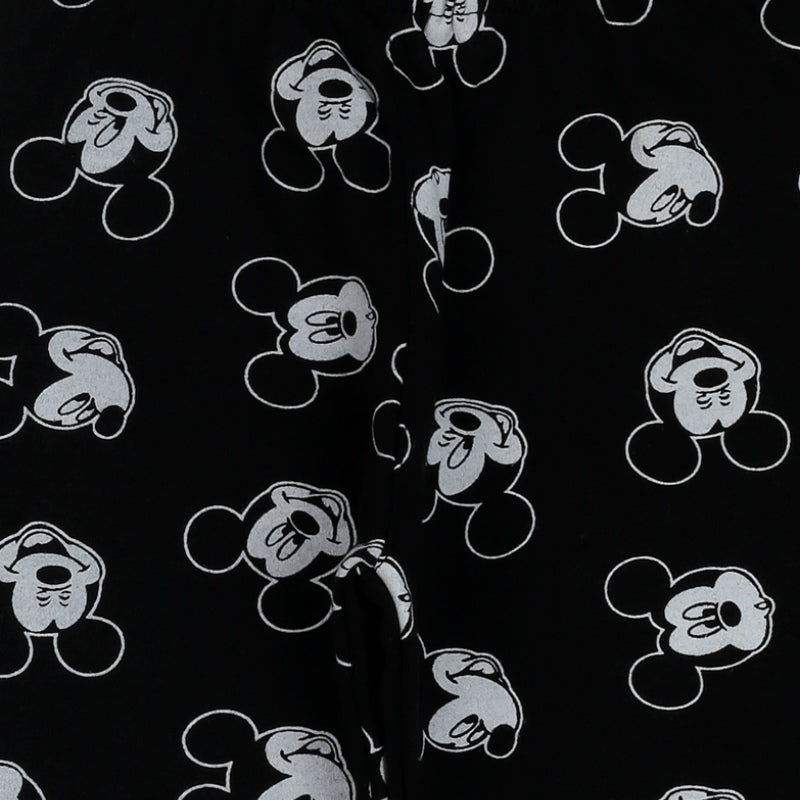 Black kids apparel fabric with white cartoon mouse face print, close-up view