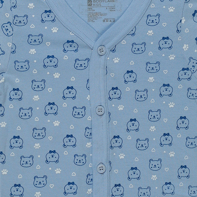 Light blue baby onesie with blue bear faces, paw prints, white hearts, and button front
