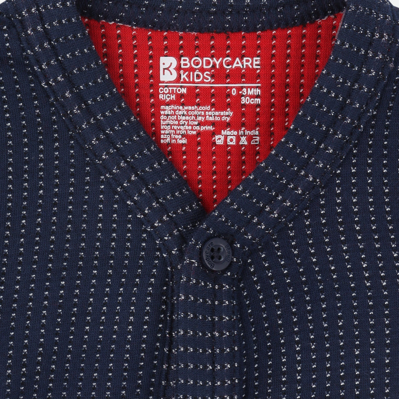 Close-up of navy blue striped baby innerwear cardigan with button front and red lining
