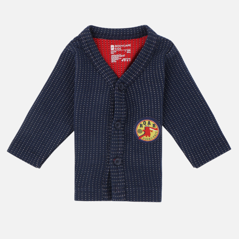 Navy blue kids' winter thermal top with white dotted pattern and dinosaur roar patch