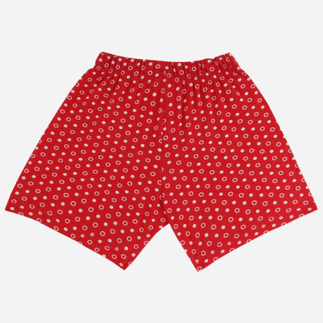 Red kids shorts with white polka dot pattern and elastic waistband on white background