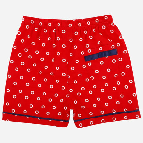 Red kids' boxer shorts with white polka dots, navy trim, and single back pocket